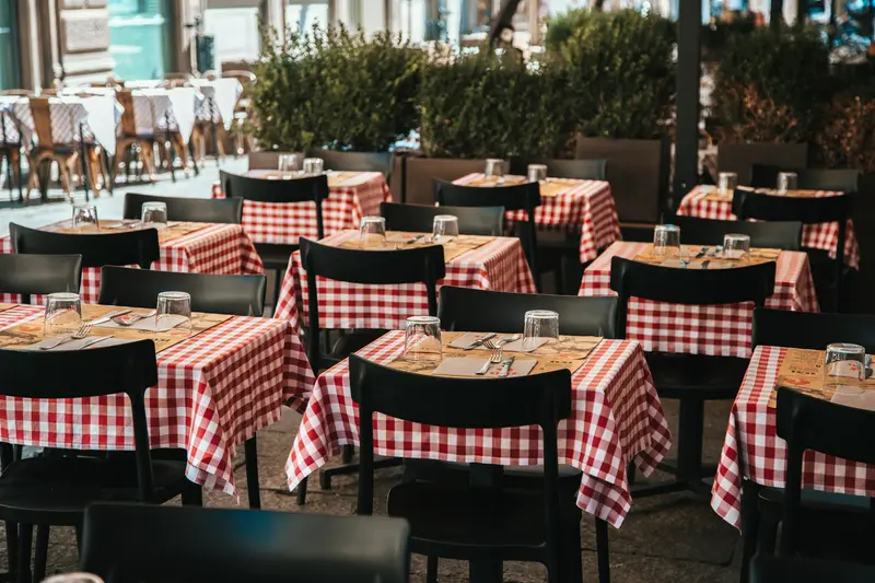 Tables with red checked tablecloths in a small dining room