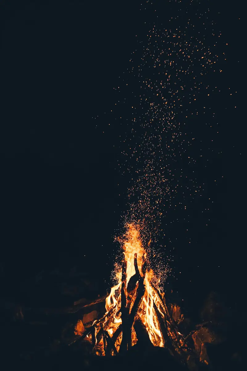 Sparks rising from a fire in the dark